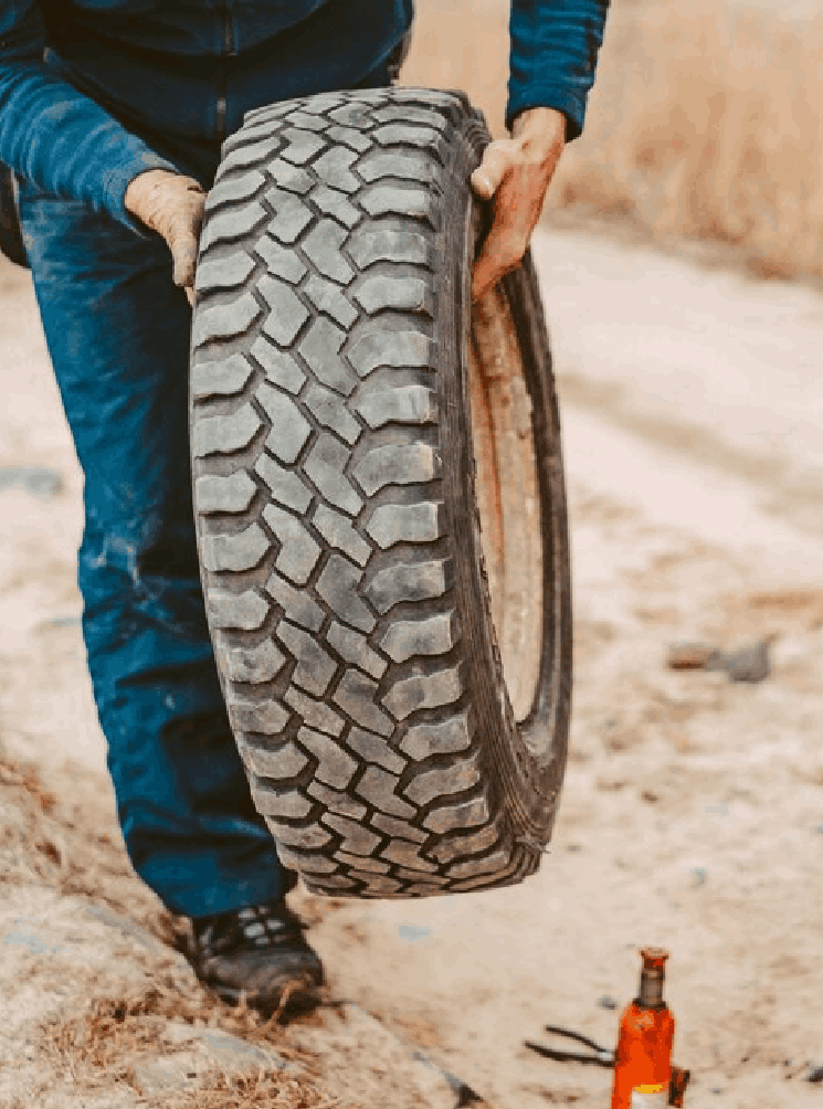 Man change the wheel manually on a 4x4 off road truck Man change the wheel manually on a 4x4 off road truck<br />